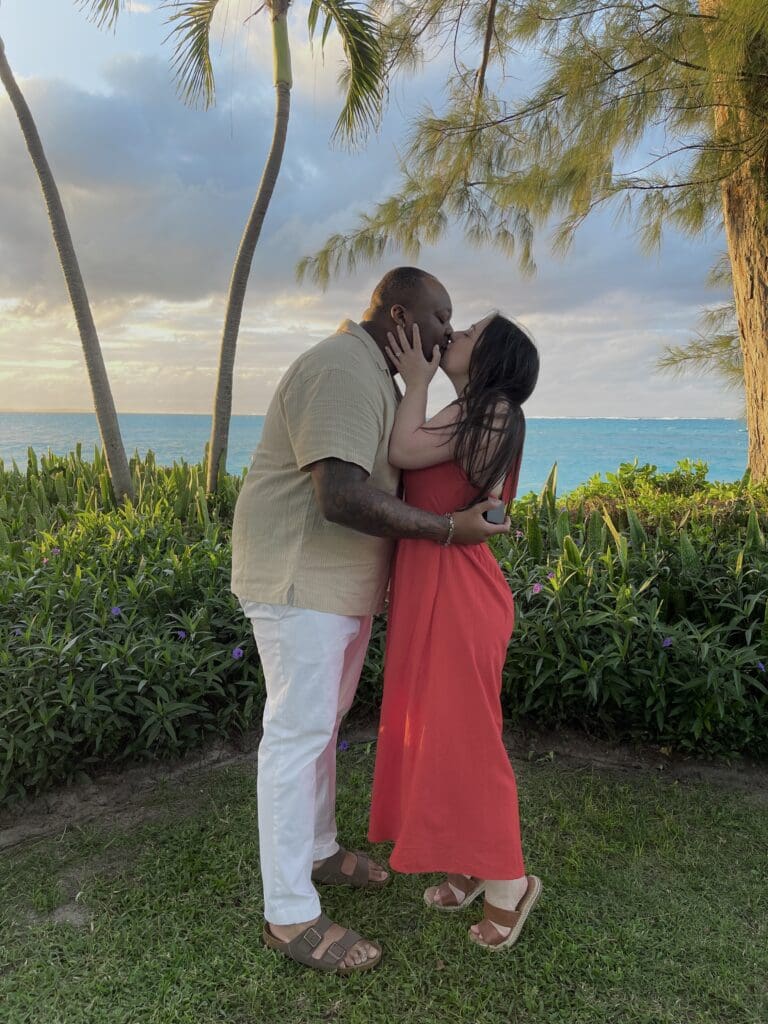 A dark photo of a couple kissing after getting engaged.