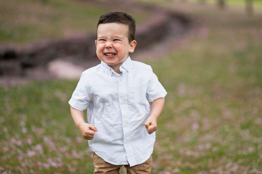 A young child is smiling big.